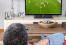 man watching football match at home
